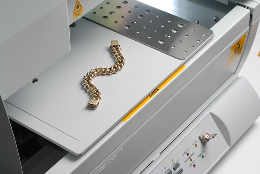 A gold bracelet inside an XRF machine